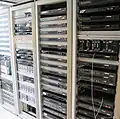 Satellite TV reception equipment, on the right and center there are DVB Asynchronous serial interface multiplexers to package several channels in one DVB Asynchronous serial interface stream to prepare it for distribution via the HFC network, just before the edge QAMs[105]