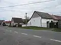 Houses by the main road with a bus stop