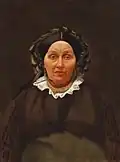 A 19th century Belarusian Jewish woman wearing a wig underneath a silk cap or bonnet