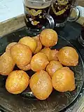 Lokma or awameh pieces are dipped in qatir. [20]