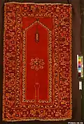 "Re-entrant" or "keyhole" prayer mat, also called a Bellini carpet, Anatolia, late 15th to early 16th century. The mat symbolically describes the environment of a mosque, with the entrance (the "keyhole"), and the mihrab (the forward corner) with its hanging mosque lamps. Metropolitan Museum of Art