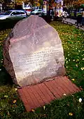 A rock with a commemorative plaque dedicated to the emblem of Rodło.