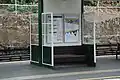 Waiting enclosure of glass & metal.