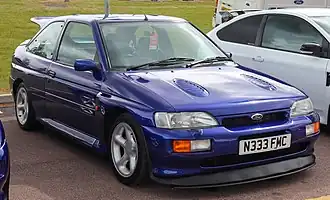A medium-sized front-engined car with three doors and a rear aerofoil