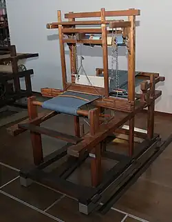 Narrow tanmono loom with an obvious shuttle race on a top-mounted beater bar. Late 1800s Japan.