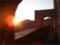 View along Panayia Yiatrissa's western, arch-adorned rampart at sunset.