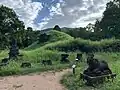 The ruins of Mỹ Sơn E1 with E4 in the background as of 2024. The structures were annihilated during the Vietnam War by US bombings