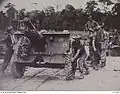 Flatcars being used to transport an Australian Ordnance QF 25-pounder Short in Seria, 1945.