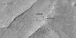 Blocks probably formed after fracturing in ridges, as seen by HiRISE under HiWish program
