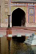 The courtyard ablution pool features a small fountain.