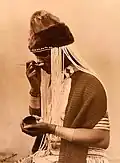 A witch doctor taking snuff. Alfred Duggan-Cronin. South Africa, early 20th century. The Wellcome Collection, London