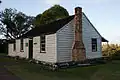 Acacia Cottage, exterior, showing the external brick chimney.