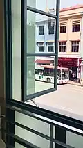 An adult toy store as seen from a window in the mosque.