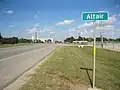 Beyond the Altair sign on US 90A is the Highway 71 junction and the rice dryer, Kallina Dryer Inc. The view is east.