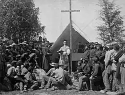 Chaplain leading prayers-69th New York Infantry Irish Brigade. Note the use of civilian hats by the men.