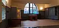 Post office: hall with a design telephone booth and writing desk, seen from the counter