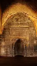 Arabic inscriptions on the stone walls inside the Adina Mosque