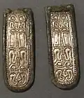 Strap ends, silver and bronze, decorated with pressed sheet metal