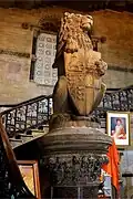 A lion puissant holding the Imperial coat of arms of Bombay. In the backdrop is a portrait of Jagannath Shankarseth, one of the founding fathers of the city of Mumbai.