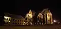 At night, from Abbatial Yard to the south; artificial light highlights the buttresses