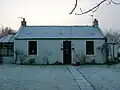 The old mine manager's house. A mound extends into this house's garden.