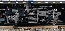 Closeup of a EMD Blomberg M truck on an MPI F40PH-3C