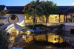 Bridge reflecting in the lake in the evening (Dunedin Chinese Garden)