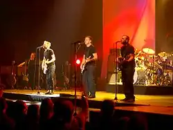 Fisher (far right) on stage with Adams and his band in Victoria, British Columbia in 2006.