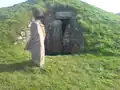 South-west side. A replica of the decorated stone stands outside the south-west opening in the burial chamber.