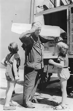 Deliveryman with a large ice block on his shoulder