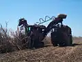 A cane harvester collects cane for the mill, 2007