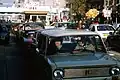 East Germans drive their vehicles through Checkpoint Charlie as they take advantage of relaxed travel restrictions to visit West Germany. The car is Lada 2102.
