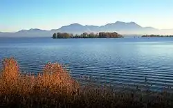 Krautinsel with (right) a small part of the Herreninsel island and in the background the Chiemgau Alps