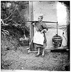 Woman with two buckets of night-soil
