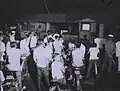 Civilians watch TV on the Saigon waterfront in January 1967