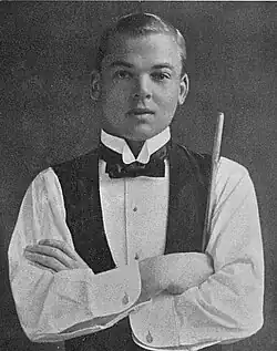 Falkiner standing with his arms crossed