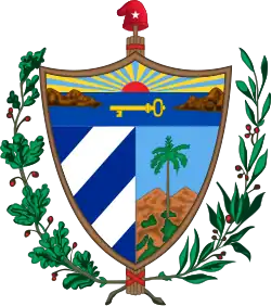 A shield in front of a Fasces crowned by the Phrygian Cap, all supported by an oak branch and a laurel wreath