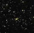 Abell 1300 acts like a lens, bending the very fabric of space around it.[27]