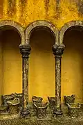 Yellow courtyard archway with stone baskets