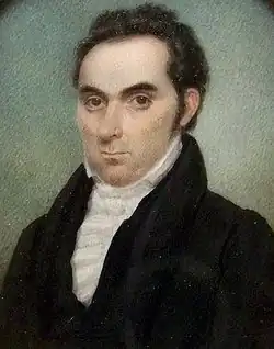 A portrait of a balding man in formal garb looking left