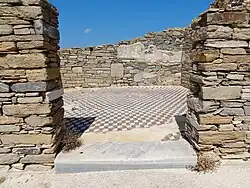 Cubic geometric-patterned floor mosaic in the ruins of a home