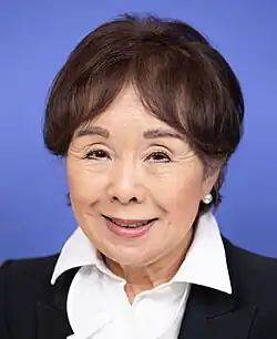 Headshot of Matsui on a light blue background