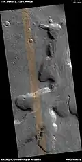 Flat floored valley with steep cliffs in fretted terrain, as seen by HiRISE under HiWish program