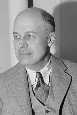 Black-and-white photo of Edward Hopper in 1937, seated and facing left