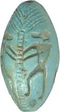 Monkey next to a palm, symbolizing the sun god's daily rising, on an Egyptian amuletic bead (ca. 1300 BC)