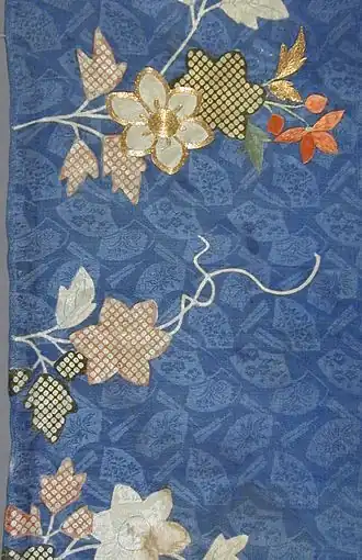 Rinzu (figured silk) dyed with a blue ground and patterns including shibori (tie-dyed) dots, plus gold embroidery