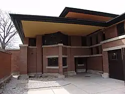 The facade at the eastern end of the house's southern "vessel". There is a protruding window bay shaped like a ship's prow. Above it is a deeply overhanging roof.