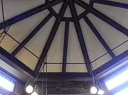 The drafting room ceiling, which was restored in the 1980s. The ceiling has wooden beams and is octagonal in shape.