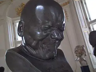 An Arch-Rascal (no. 33 in a character head series); by Franz Xaver Messerschmidt; after 1770; alabaster; height: 38&nbsp;cm; Österreichische Galerie Belvedere, Vienna, Austria[44]
