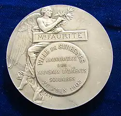 Color photograph of a medal.